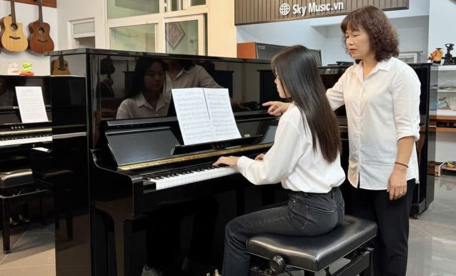 Giáo viên hướng dẫn học viên chơi piano cơ Yamaha tại Sky Music Long Biên